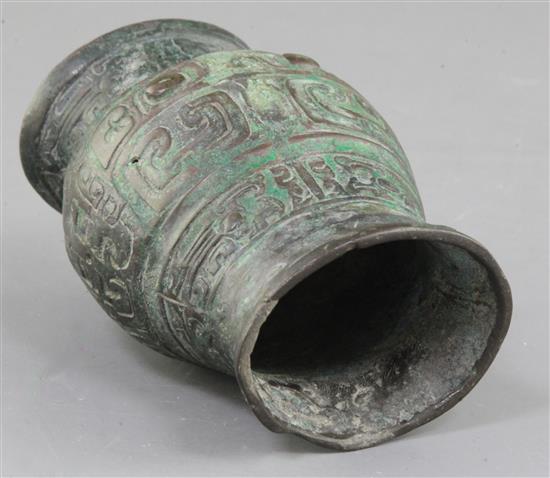 A small Chinese archaic bronze ritual wine cup, Zhi, Western Zhou dynasty, 11th century B.C., 11cm high, hole and rim repairs